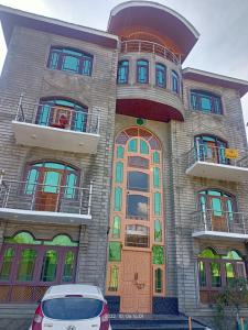 a building with a car parked in front of it at HOTEL MERLIN PALACE in Srinagar