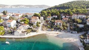 an aerial view of a town with a beach at Modern Seafront Villa Steps from the Beach in Rogoznica