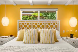 a bedroom with a white bed with yellow walls at DreamCatcher South Walk to Shop Dine Hike in Sedona