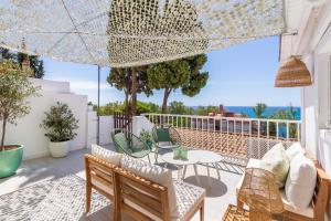 a patio with a table and chairs on a balcony at Casa de la Playa. Beach House with magnificent sea in Málaga