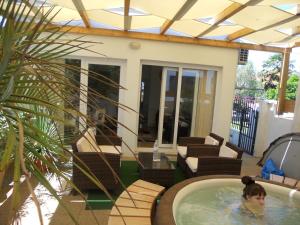 a woman in a hot tub on a patio at Apartment Teuta in Zadar