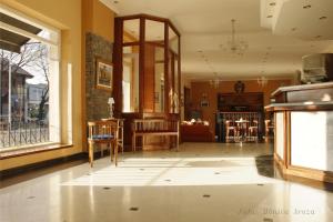 a living room with a table and chairs in a room at Hotel Francia in Tandil