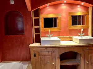 a bathroom with two sinks and a red wall at Chalet haut de gamme 5 chambres avec hammam, proche des pistes - FR-1-293-211 in Villard-sur-Doron
