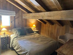 Villard-sur-DoronにあるChalet Villard-sur-Doron, 6 pièces, 14 personnes - FR-1-293-211の木製の壁のベッドルーム1室(大型ベッド1台付)