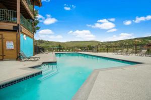 a swimming pool at a resort with blue water at Silver Creek - Door 418 in Granby