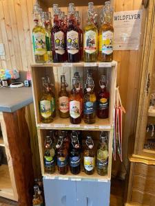 a bunch of bottles of alcohol on a shelf at In A Meading - Safari Tent - BeeWeaver Honey Farm in Navasota