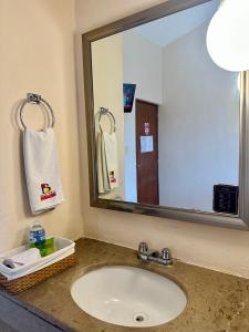 baño con lavabo y espejo grande en Hotel Barranquilla, en Campeche
