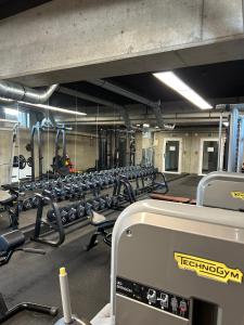 a gym with several rows of machines in it at Brand New !!! Baltic Marina Residence Sauna & Fitness Apartments- Royal Green Apartments, Ferienwohnung polnische Ostsee in Kołobrzeg