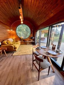 a living room with a table and a couch at The Pines Treehouse at Treetops Hideouts in Richmond