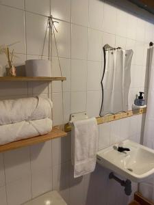 y baño con lavabo, aseo y toallas. en Flor de León Café - Hostal, en Barichara