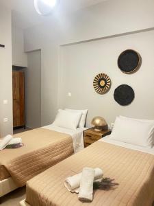 a bedroom with two beds with towels on them at LA COSTA DI SAN GIORGIO in Agios Georgios