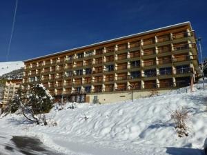 a large building on top of a snow covered mountain at Appartement Huez, 2 pièces, 6 personnes - FR-1-405-162 in LʼHuez