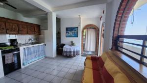 a kitchen with a table in the middle of a room at Villa frente al mar en Yelapa para 2 personas in Yelapa