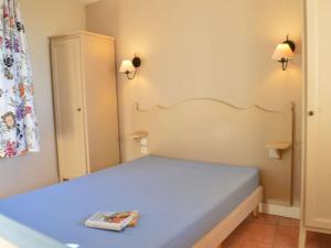 a small bedroom with a bed with a book on it at Appartement 6 couchages avec piscine et parking aux Issambres - FR-1-226-386 in Les Issambres