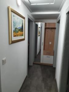 a hallway with a painting hanging on a wall at Ferienwohnung Paul in Losheim