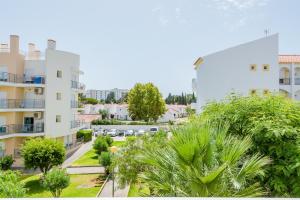 an aerial view of an apartment complex with palm trees at Alfamar Apartment at Praia da Falesia in Albufeira