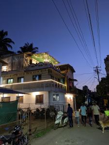 a group of people walking in front of a building at Awaara Backpackers Hostel, Alibag in Alibag