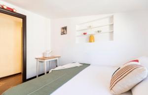 a bedroom with a white bed with a mirror at MiCo Apartment in Fiera Milano City in Milan