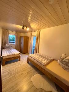 una camera con 2 letti e un pavimento in legno di FLAIR Bad Rodach - 5 Sterne Ferienwohnungen a Bad Rodach