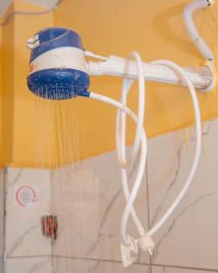 uma escova azul e branca pendurada numa parede em cla bnb em Kisumu