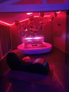 a room with a bed with red lights in it at Loft d'amour in Ligné