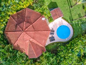 an overhead view of a house with a red umbrella and a pool at Lomas del Caribe in Puerto Viejo
