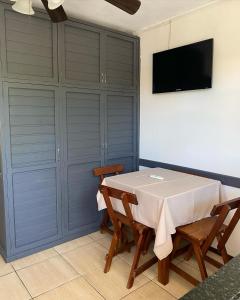 uma sala de jantar com uma mesa e uma televisão na parede em Hotel Mirador del Dayman em Termas del Daymán