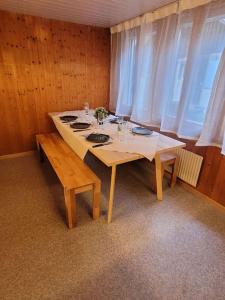 a dining room with a table in a room at Staubbach View - Traditional Chalet Apartment in Lauterbrunnen