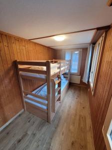 a room with two bunk beds in a house at Staubbach View - Traditional Chalet Apartment in Lauterbrunnen