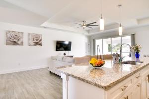 a kitchen and living room with a counter top at Comfy Lehigh Acres Getaway with Yard and Fireplace in Lehigh Acres