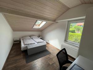 una piccola camera con letto e finestra di Ferienhaus Liebenstein a Bad Koetzting