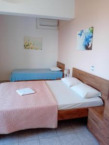 Ένα ή περισσότερα κρεβάτια σε δωμάτιο στο Ενοικιαζόμενα Διαμερίσματα Γαλήνη