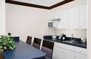 a kitchen with white cabinets and a blue counter top at Hampton Inn Asheboro in Asheboro