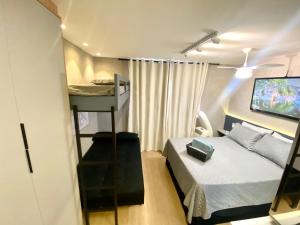 a small room with a bed and a tv at MV 77A Incrível Apartamento Em Frente Ao Metrô Brás ! - Rua Coronel Mursa, 56 - Bras in Sao Paulo +37 photos