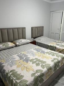 two beds sitting next to each other in a room at Hotel Amigo in Yerevan