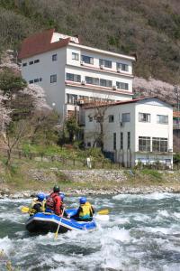 a group of people in a raft in a river at Oyado Matsubaya in Minakami