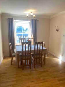 a dining room with a table and chairs and a window at 47 High Street in Alness