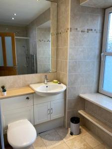 a bathroom with a white toilet and a sink at 47 High Street in Alness