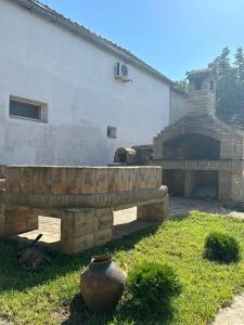 a stone fireplace in front of a house at Sobe Šponga 4, in Kikinda