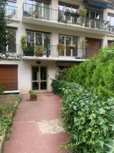 a building with a walkway in front of it at Porte Maillot-Charming and calm studio at Neuilly in Neuilly-sur-Seine