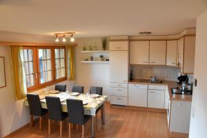 a kitchen and dining room with a table and chairs at Haus Brunnen (Anton Karlen) in Riederalp
