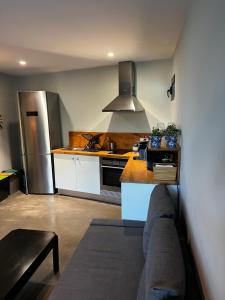 a kitchen with a couch and a stove top oven at The Loft Junction in Funchal +38 photos