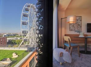 a room with a view of a ferris wheel at Adina Apartment Hotel Munich in Munich