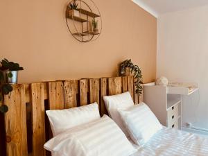a bedroom with a wooden headboard and two white pillows at Gîte Familie 
