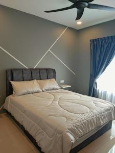a bedroom with a bed with a ceiling fan at 7&9 Manhattan Condominium Ipoh in Ipoh