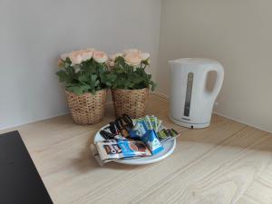 a plate of food on a table with two flowers at Aalborg City Rooms ApS in Aalborg