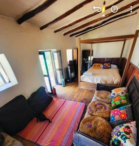 a bedroom with a bed and pillows on the floor at Wolf Totem Steam Punk Loft Villa in Pisac