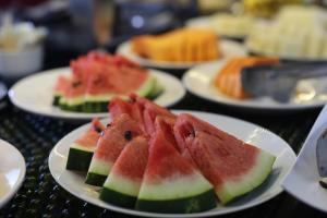 a group of plates of watermelon slices on a table at Stop Inn Antonio Carlos in Belo Horizonte