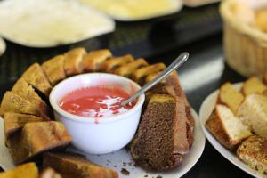 a plate of food with a bowl of dipping sauce at Stop Inn Antonio Carlos in Belo Horizonte
