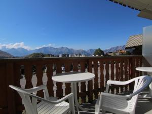 a white table and chairs on a balcony with mountains at Studio cosy pour 5 pers. à 50m des pistes - Alpe d'Huez - FR-1-405-200 in LʼHuez +3 photos